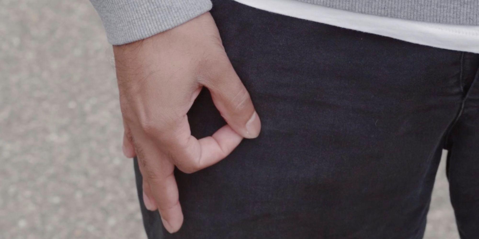 Open hand in pocket gesture