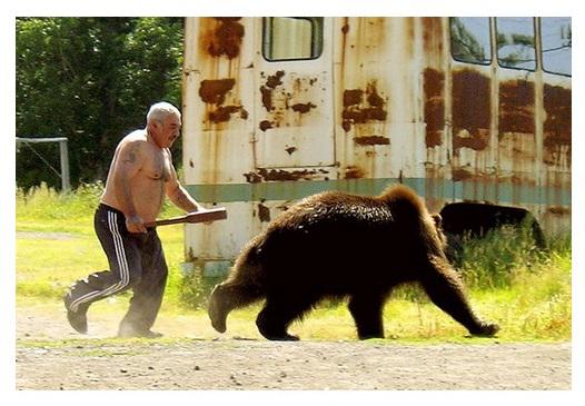 Open man plays with bear near train